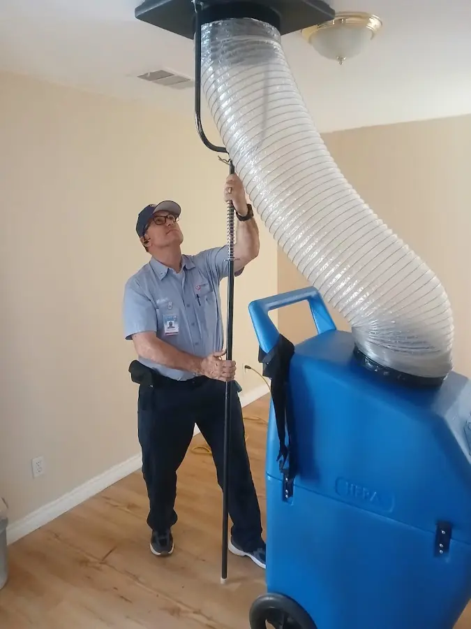 Furnace Tune-Up technician using HEPA equipment in Deltona